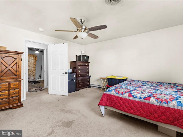 carpeted bedroom with visible vents, baseboard heating, and ceiling fan