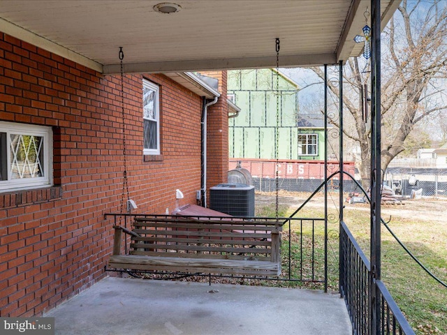 view of patio featuring cooling unit and fence