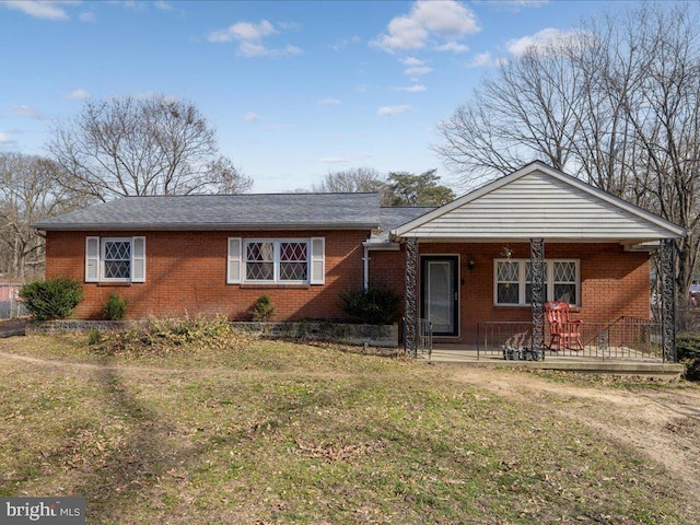 ranch-style home featuring brick siding and a front lawn