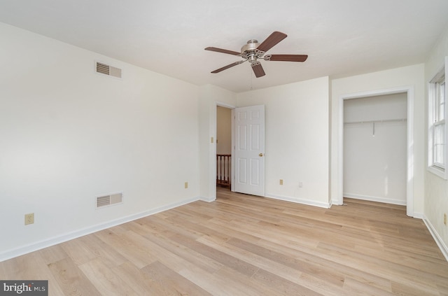 unfurnished bedroom with a closet, baseboards, visible vents, and light wood finished floors