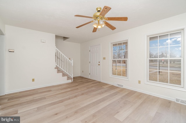 entrance foyer featuring visible vents, baseboards, stairs, and light wood finished floors