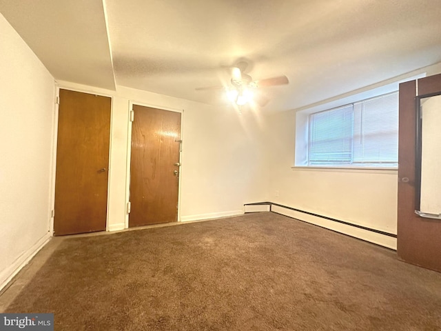 unfurnished bedroom with a baseboard radiator, carpet floors, and a ceiling fan