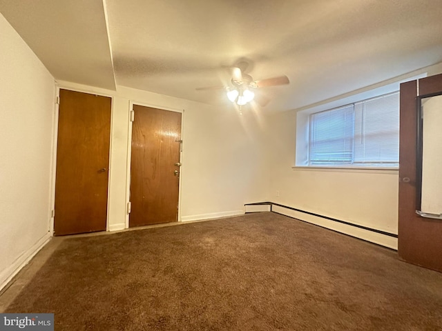 unfurnished bedroom with baseboard heating, baseboards, carpet floors, and ceiling fan