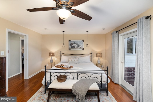 bedroom with ceiling fan, baseboards, and wood finished floors