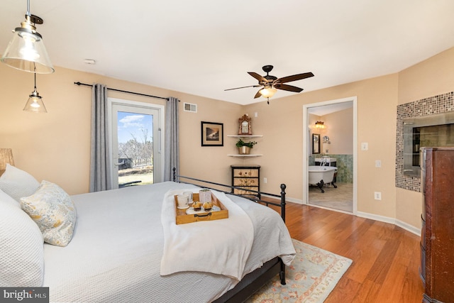 bedroom with visible vents, access to outside, wood finished floors, baseboards, and ceiling fan