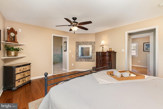 bedroom with wood finished floors, baseboards, and ceiling fan