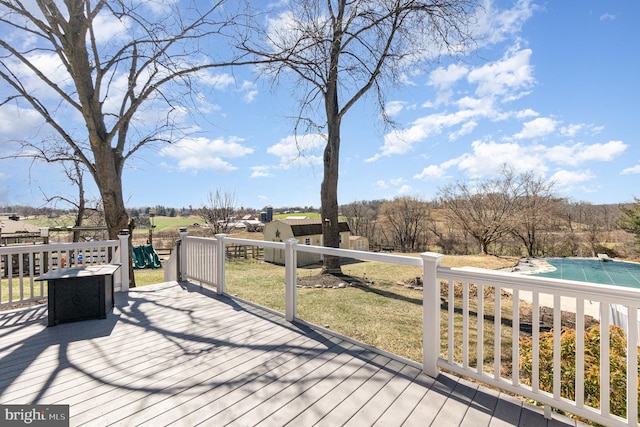 wooden deck with an outbuilding and a yard