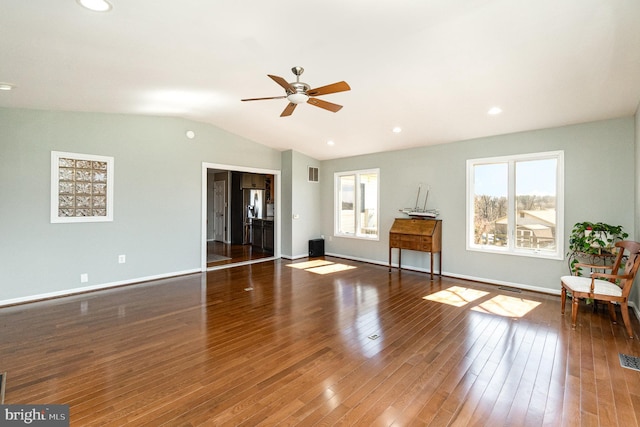 unfurnished living room featuring vaulted ceiling, baseboards, visible vents, and hardwood / wood-style floors