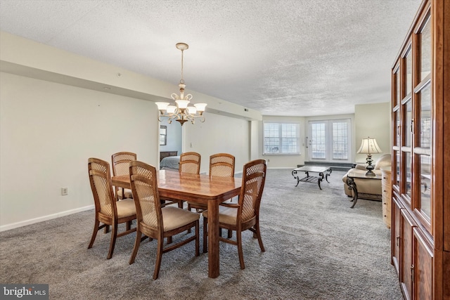 dining area featuring an inviting chandelier, baseboards, dark colored carpet, and a textured ceiling