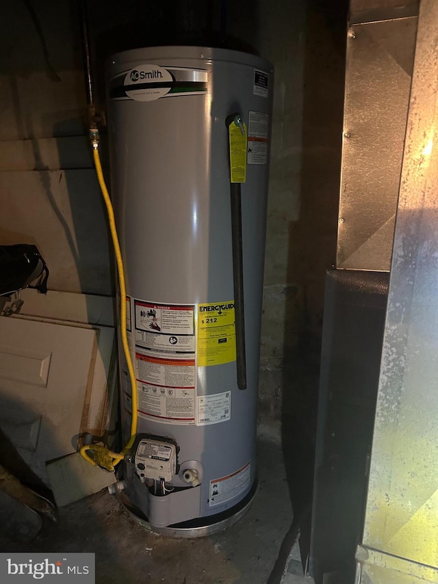 utility room featuring water heater and heating unit