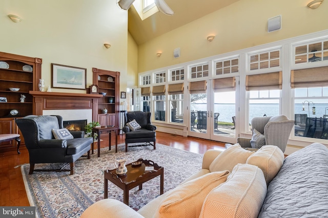 11520 Magnolia Ct, Issue, MD 20645 - living area featuring wood finished floors, a lit fireplace, and high vaulted ceiling
