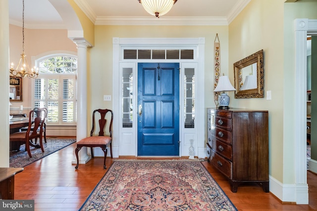 11520 Magnolia Ct, Issue, MD 20645 - foyer with hardwood / wood-style floors, crown molding, arched walkways, a chandelier, and baseboards