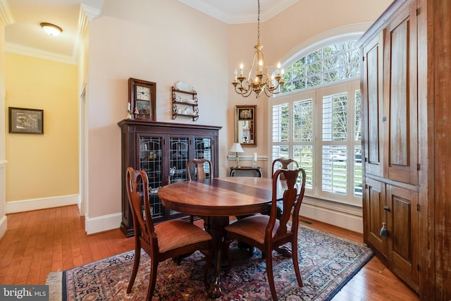 11520 Magnolia Ct, Issue, MD 20645 - dining area with light wood-style flooring, plenty of natural light, a chandelier, crown molding, and baseboards