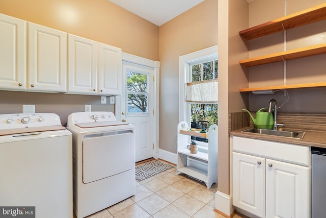 11520 Magnolia Ct, Issue, MD 20645 - washroom featuring washer and clothes dryer, cabinet space, and light tile patterned flooring