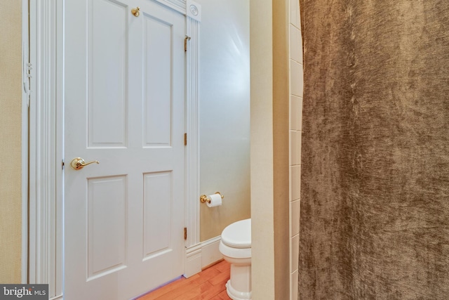 11520 Magnolia Ct, Issue, MD 20645 - bathroom featuring wood finished floors, toilet, and a shower