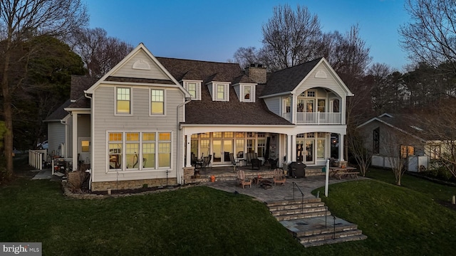 11520 Magnolia Ct, Issue, MD 20645 - rear view of house featuring a balcony, a chimney, a yard, a patio, and a shingled roof