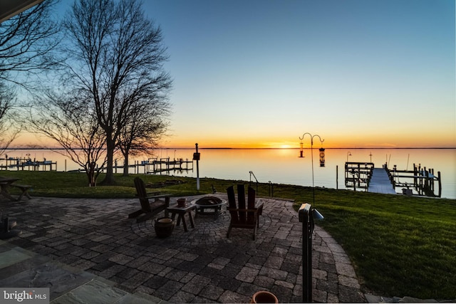 11520 Magnolia Ct, Issue, MD 20645 - patio terrace at dusk with a lawn, an outdoor fire pit, a water view, a patio area, and a boat dock