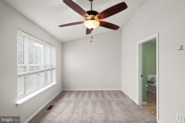 spare room with a ceiling fan, carpet, visible vents, and baseboards