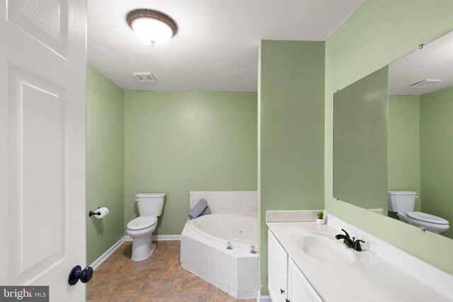 bathroom with vanity, a garden tub, toilet, and visible vents