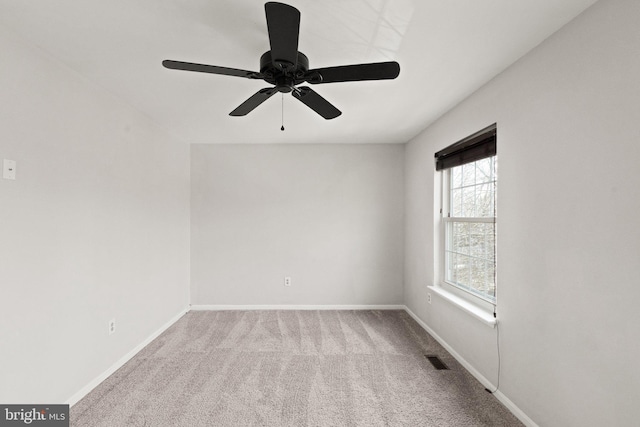 carpeted empty room with visible vents and baseboards