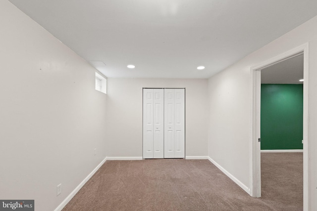 unfurnished bedroom with recessed lighting, baseboards, carpet floors, and a closet