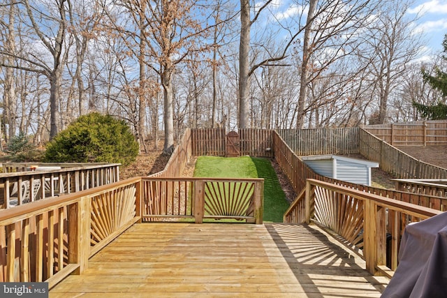 deck featuring grilling area and a fenced backyard