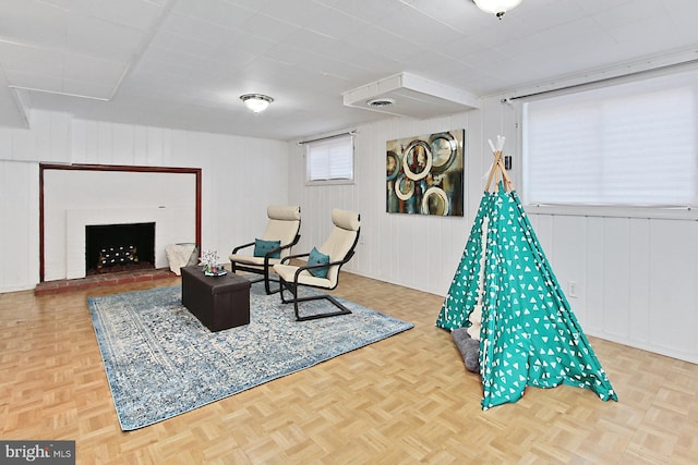 rec room with visible vents, parquet floors, and a fireplace