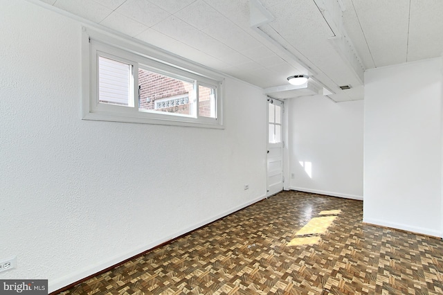 empty room featuring visible vents and baseboards