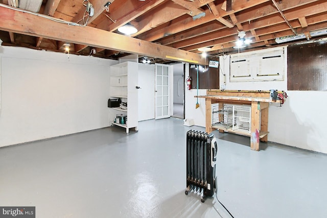 unfinished basement featuring radiator heating unit