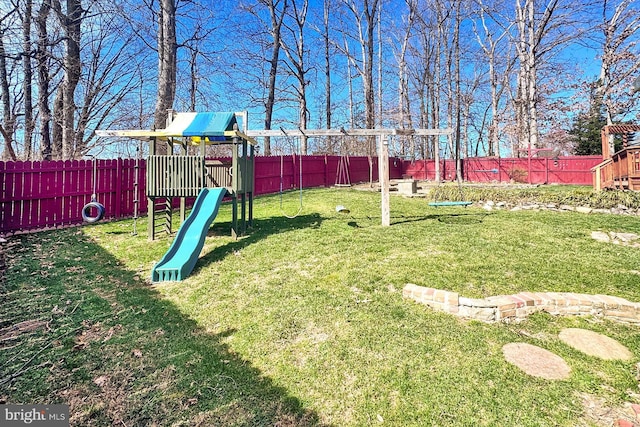 view of yard with a fenced backyard and a playground