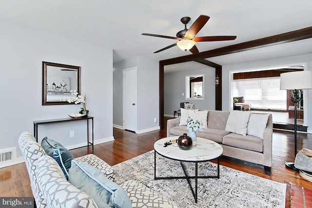 living area with visible vents, ceiling fan, baseboards, and wood finished floors