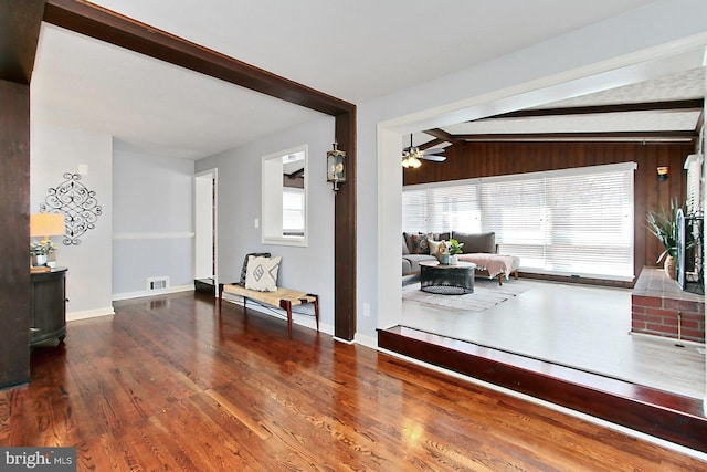 interior space featuring visible vents, a healthy amount of sunlight, lofted ceiling with beams, and wood finished floors