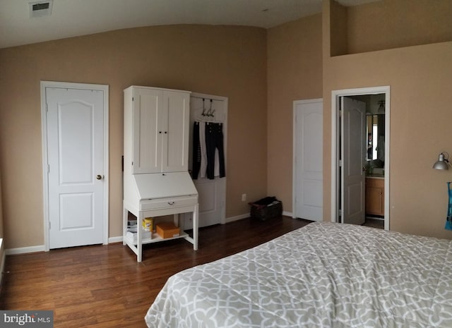 bedroom with visible vents, baseboards, dark wood finished floors, and vaulted ceiling