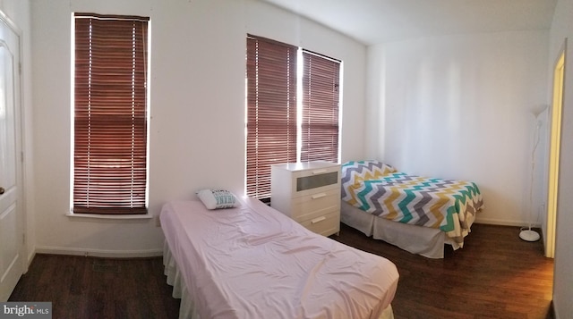 bedroom featuring wood finished floors and baseboards