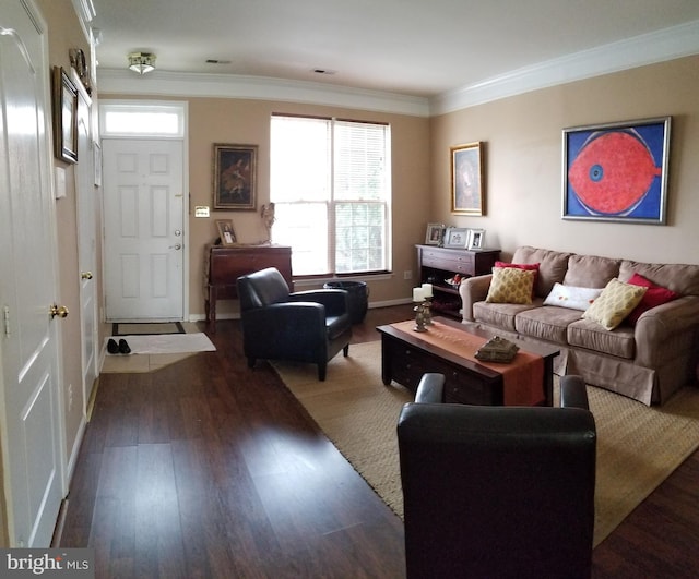 living room with visible vents, baseboards, wood finished floors, and crown molding