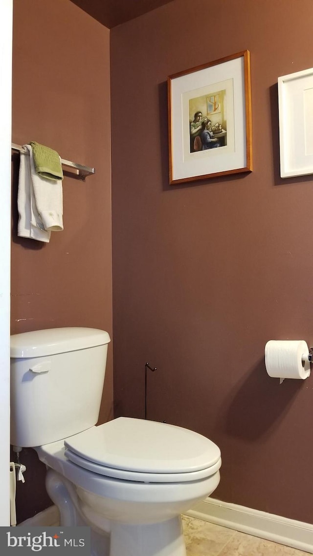 bathroom with toilet and baseboards