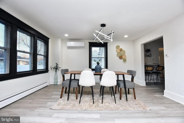 dining room featuring a wall mounted air conditioner, a notable chandelier, baseboard heating, and wood finished floors