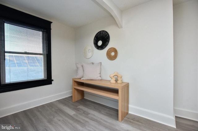 room details with beam ceiling, baseboards, and wood finished floors