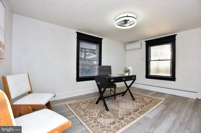 home office with baseboard heating, a wall mounted AC, baseboards, and wood finished floors