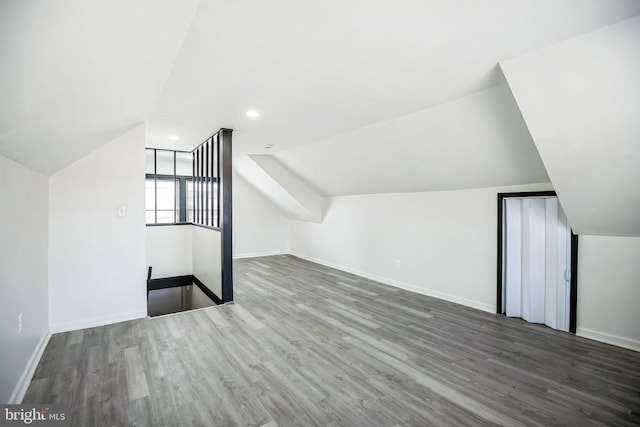 bonus room featuring recessed lighting, baseboards, wood finished floors, and vaulted ceiling