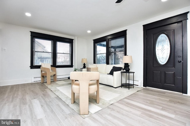 entrance foyer featuring recessed lighting, light wood-type flooring, and baseboard heating