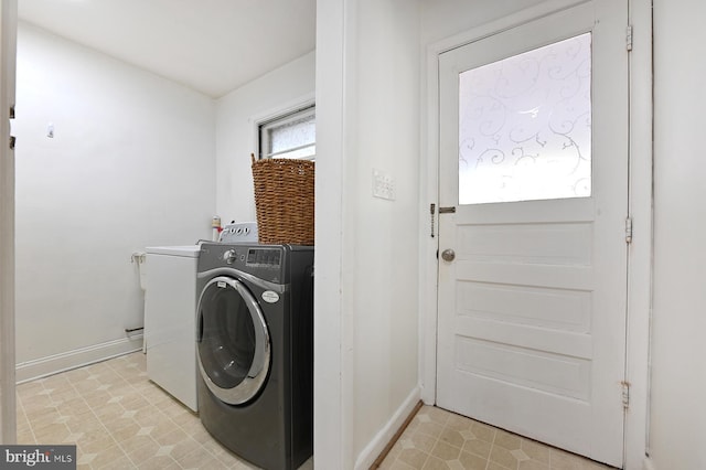 laundry area featuring laundry area, washer / clothes dryer, and baseboards