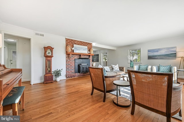 living area featuring visible vents, baseboards, and light wood-style floors