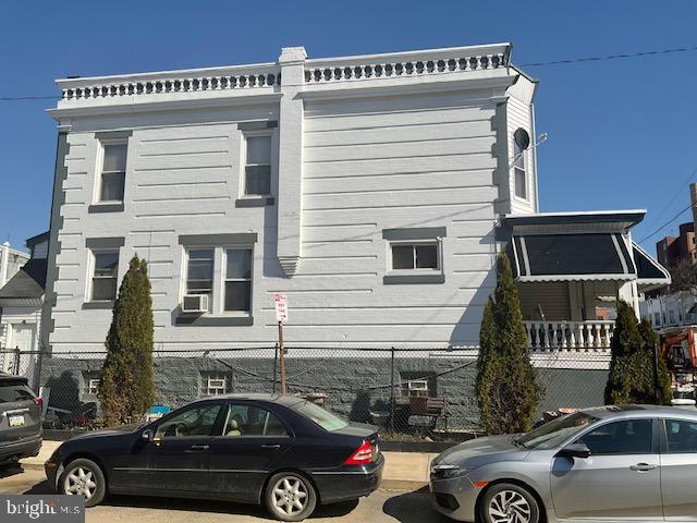 view of home's exterior featuring cooling unit and fence