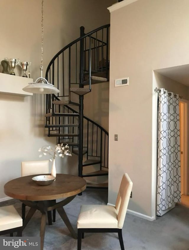 dining area with visible vents, baseboards, concrete floors, and stairs