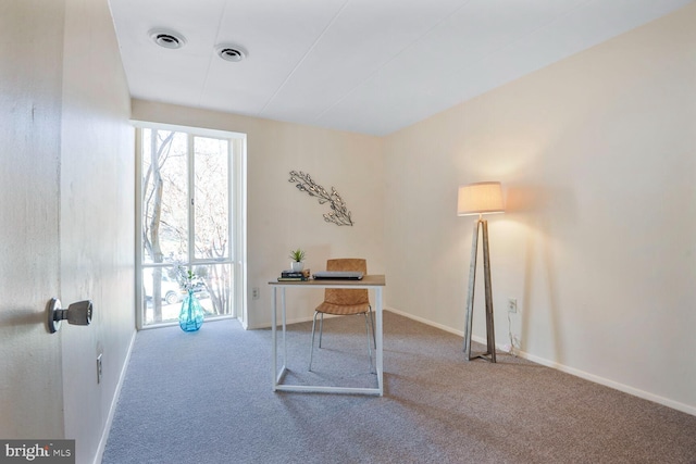 unfurnished office featuring visible vents, baseboards, and carpet