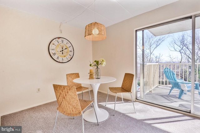 dining room featuring baseboards and carpet flooring