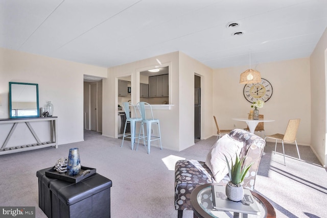 living area featuring baseboards and carpet floors