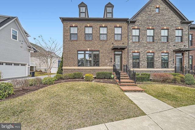 view of front of house with brick siding and a front yard