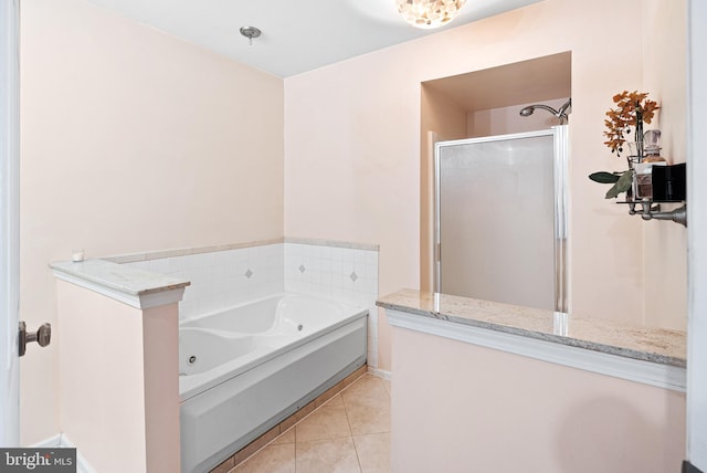 full bathroom featuring tile patterned floors, a garden tub, and a stall shower